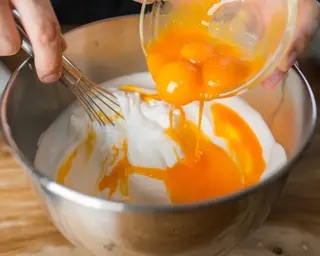 mixing in yolk to egg white mixture